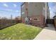 Private backyard with a green lawn, a brick and siding exterior, and a well-maintained fence at 2624 N Clay St, Denver, CO 80211