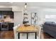 Open dining area with modern lighting, a spacious table, and seamless flow to the kitchen and living spaces at 2624 N Clay St, Denver, CO 80211