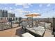Stunning roof deck with city views, cozy seating, and a stylish fire pit for outdoor relaxation at 2624 N Clay St, Denver, CO 80211