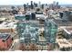 Stunning aerial view of modern building with city skyline backdrop, showcasing urban living at 1700 Bassett St # 314, Denver, CO 80202