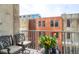Cozy balcony seating area with a potted plant and a view of surrounding buildings at 1700 Bassett St # 314, Denver, CO 80202