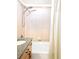 Bathroom tub with shower and a beige-tiled wall, next to a granite-countered vanity at 1700 Bassett St # 314, Denver, CO 80202