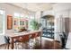 Elegant dining room with a large table, stylish chairs, modern chandelier, and city views at 1700 Bassett St # 314, Denver, CO 80202