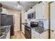 Bright kitchen featuring white cabinetry, modern appliances, and granite countertops at 1948 S Balsam St, Lakewood, CO 80227