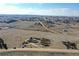 Aerial view of lot under construction in an established neighborhood with scattered homes and a country road at 1286 Lisbon Dr, Parker, CO 80138