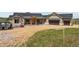 New construction home featuring a two-car garage, wood accents, and stone exterior at 1286 Lisbon Dr, Parker, CO 80138