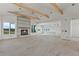 Open unfinished living room showcasing beam ceilings, fireplace, and recessed lighting at 1286 Lisbon Dr, Parker, CO 80138