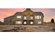 View of home showcasing its back facade, large windows, and rear patio at 1286 Lisbon Dr, Parker, CO 80138