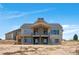 Rear exterior showcasing the covered patio, abundant windows, and spacious design at 1286 Lisbon Dr, Parker, CO 80138