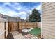 Fenced backyard with stone pathway and unique patch of artificial turf at 18397 E Alabama Pl # D, Aurora, CO 80017