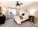 Bright bedroom with ceiling fan, a comfy queen-sized bed and natural light streaming through the window at 18397 E Alabama Pl # D, Aurora, CO 80017
