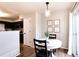 Charming dining area with a round table, modern light fixture, and sliding glass door at 18397 E Alabama Pl # D, Aurora, CO 80017