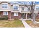 Attractive townhome with brick and siding exterior, well-maintained landscaping, and a welcoming entrance at 18397 E Alabama Pl # D, Aurora, CO 80017
