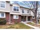Charming townhome exterior with brick and siding, manicured lawn, and inviting front entrance at 18397 E Alabama Pl # D, Aurora, CO 80017