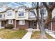Charming townhouse with a brick facade, manicured lawn, and mature tree providing curb appeal at 18397 E Alabama Pl # D, Aurora, CO 80017