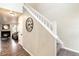 Welcoming staircase with decorative clock and view into living room featuring fireplace at 18397 E Alabama Pl # D, Aurora, CO 80017