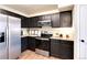Modern kitchen features stainless steel refrigerator, stove, and microwave oven with dark wood cabinets at 18397 E Alabama Pl # D, Aurora, CO 80017