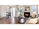 Bright living room features a fireplace, wood floors, dining table, and sliding door access to the exterior at 18397 E Alabama Pl # D, Aurora, CO 80017
