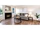 Inviting living room featuring a cozy fireplace, gray sofa, modern decor, and stylish dark wood-look flooring at 18397 E Alabama Pl # D, Aurora, CO 80017