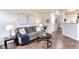 Spacious living room featuring hardwood floors, modern decor, and ample natural light at 18397 E Alabama Pl # D, Aurora, CO 80017