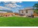 Great backyard with lush grass, hot tub, stone patio, outdoor seating, and shade trees at 2441 E 47Th Ave, Denver, CO 80216