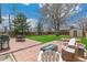 Spacious backyard featuring a patio, a fire pit, a seating area, and a lush lawn at 2441 E 47Th Ave, Denver, CO 80216