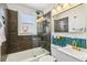 Modern bathroom featuring shower with glass doors, contemporary fixtures, and decorative tile at 2441 E 47Th Ave, Denver, CO 80216