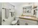 Clean bathroom with tile floors, toilet, vanity, and shower, plus updated fixtures at 2441 E 47Th Ave, Denver, CO 80216