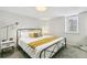 Cozy bedroom with neutral walls, large window, and a comfy bed with decorative pillows and throw at 2441 E 47Th Ave, Denver, CO 80216