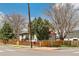 Exterior view of gray home, showcasing modern fence and mature landscaping near the intersection at 2441 E 47Th Ave, Denver, CO 80216