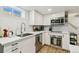 Well-lit kitchen with white cabinets, stainless appliances and modern fixtures at 2441 E 47Th Ave, Denver, CO 80216