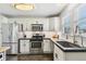 Beautiful kitchen featuring white cabinets, stainless steel appliances, and tiled backsplash at 2441 E 47Th Ave, Denver, CO 80216