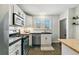 Bright kitchen with white cabinets, subway tile backsplash, and stainless steel appliances at 2441 E 47Th Ave, Denver, CO 80216