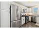 Kitchen featuring stainless steel refrigerator and appliances, plus ample storage at 2441 E 47Th Ave, Denver, CO 80216
