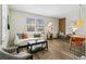 Inviting living room featuring hardwood floors, with a comfortable seating arrangement and ample natural light at 2441 E 47Th Ave, Denver, CO 80216