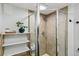 Updated bathroom with a glass shower enclosure, tiled walls, and modern fixtures at 2441 E 47Th Ave, Denver, CO 80216