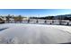 Snow-covered backyard with a view of neighboring homes at 15454 W Auburn Ave, Lakewood, CO 80228