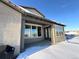 Covered patio with snow, offering views of the neighborhood at 15454 W Auburn Ave, Lakewood, CO 80228