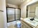 Bathroom featuring a shower with black trim, a vanity with a granite counter, and a toilet at 15454 W Auburn Ave, Lakewood, CO 80228