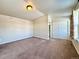 Bedroom with neutral paint, carpet, vaulted ceilings, closet, and a view into the bathroom at 15454 W Auburn Ave, Lakewood, CO 80228