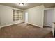 Spacious carpeted bedroom with ample natural light and a large window at 15454 W Auburn Ave, Lakewood, CO 80228