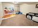 A bonus room with a carpeted floor that is set up as a playroom with toys and a birthday banner at 15454 W Auburn Ave, Lakewood, CO 80228