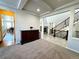 An elegant entryway featuring detailed wood furniture and stylish staircase at 15454 W Auburn Ave, Lakewood, CO 80228