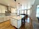 Spacious kitchen featuring granite counters, a center island, stainless appliances, and hardwood floors at 15454 W Auburn Ave, Lakewood, CO 80228