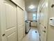 Well-organized laundry room with storage, utility sink, and closet space at 15454 W Auburn Ave, Lakewood, CO 80228