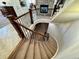 Carpeted winding staircase with dark wood railing, offering a stylish transition between floors at 15454 W Auburn Ave, Lakewood, CO 80228