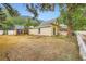 View of yard with yellow house, a stone patio and a privacy fence at 400 Argentine St, Georgetown, CO 80444