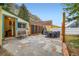 The backyard features a stone patio, wooden fencing and lush greenery at 400 Argentine St, Georgetown, CO 80444