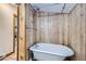 This bathroom features a clawfoot bathtub, wood paneling and unique fixtures at 400 Argentine St, Georgetown, CO 80444
