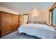 This bedroom features carpet flooring and a unique, large wooden wardrobe at 400 Argentine St, Georgetown, CO 80444